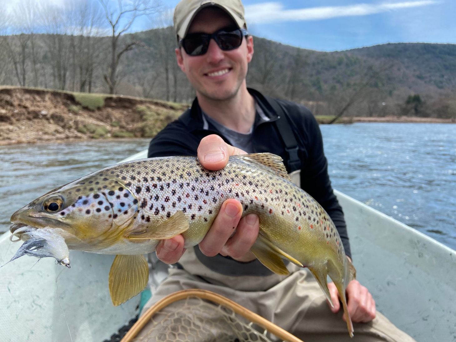 fly fisherman with brown trout