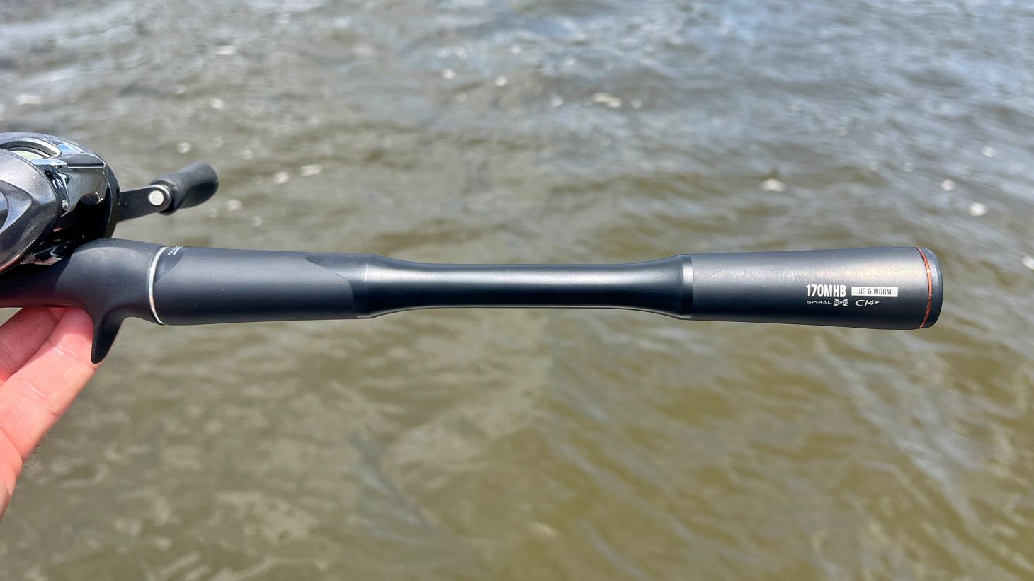 Hand holding fishing rod