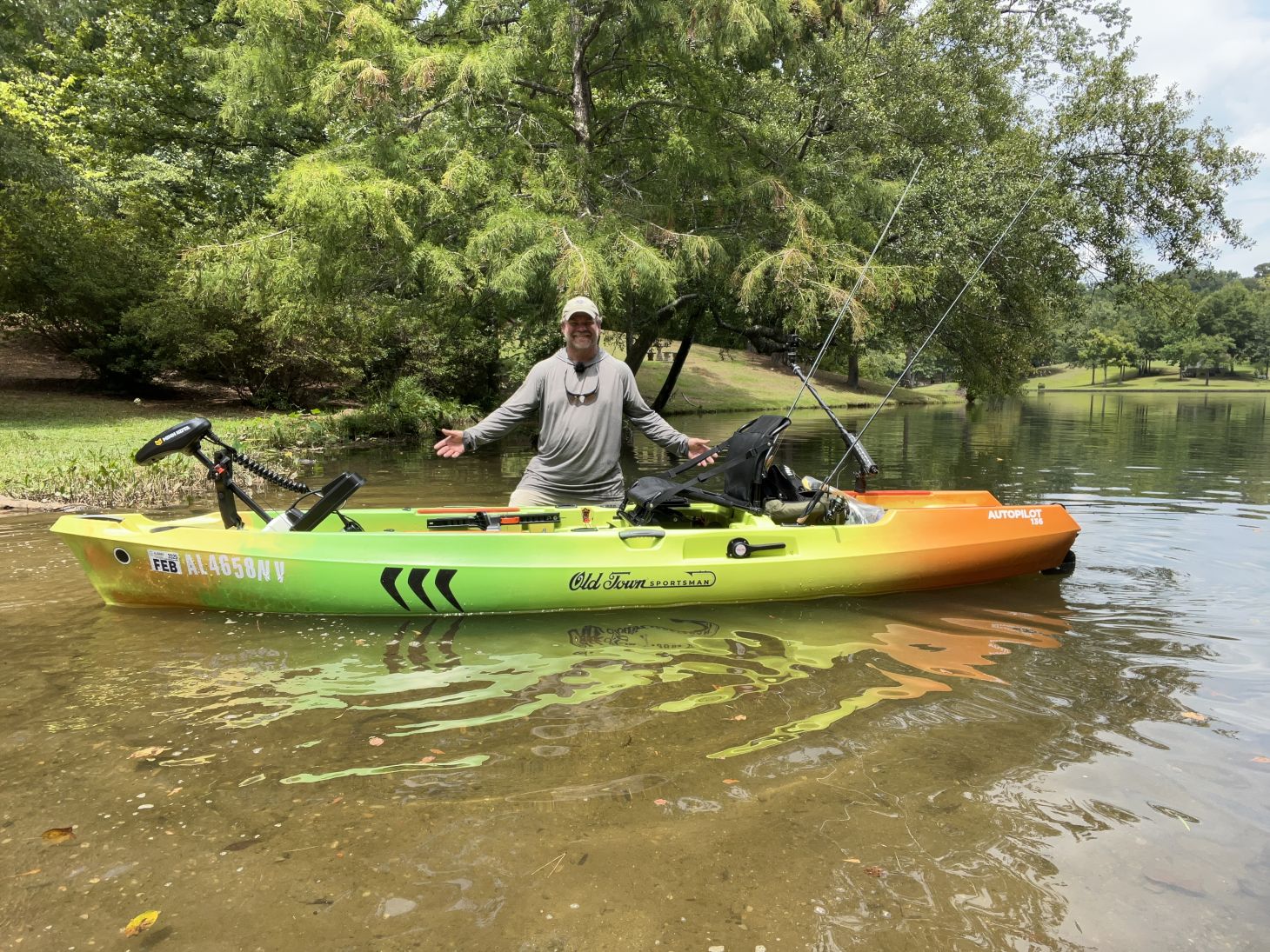 Shaye baker standing next to his old town kayak