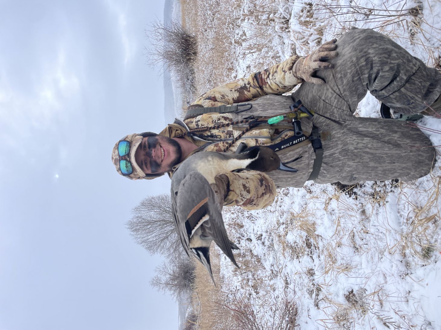 Hunter holding a drake pintail 