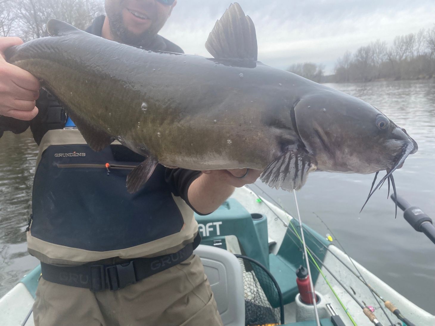 angler holding up a channel catfish. 