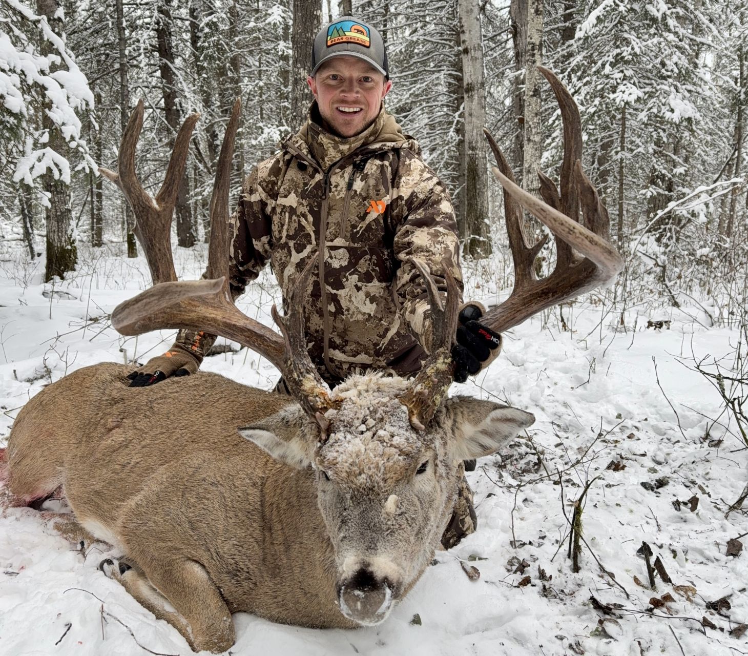 A hunter poses with a trophy whitetail buck taken in Alberta.