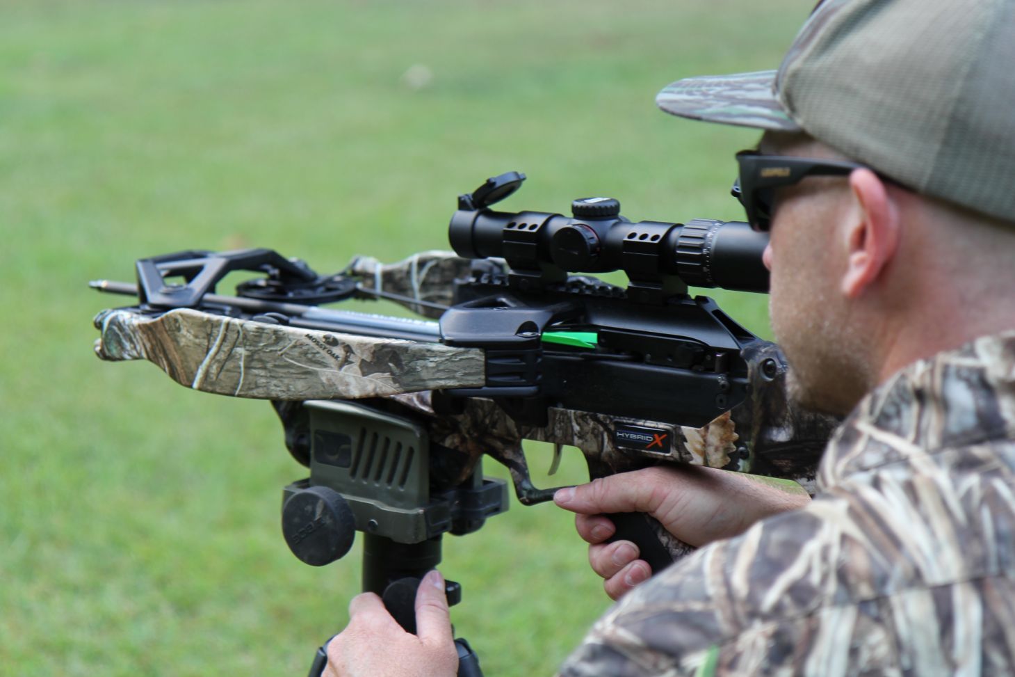 A man shoots the Excalibur Hybrid X crossbow in a yard. 