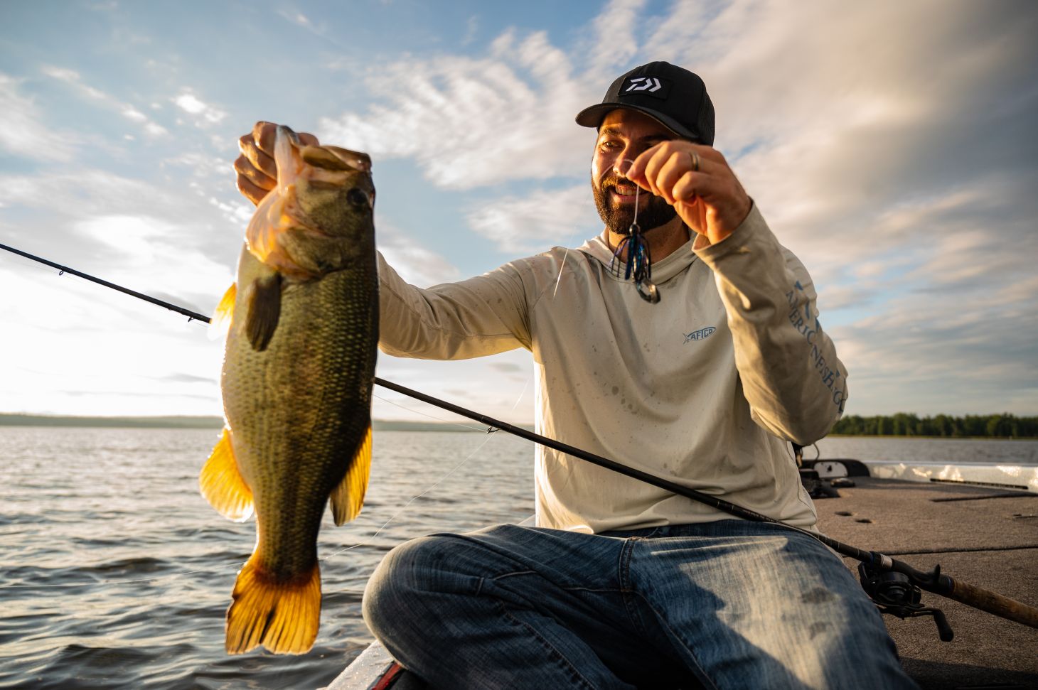 Angler holding up largemouth bass
