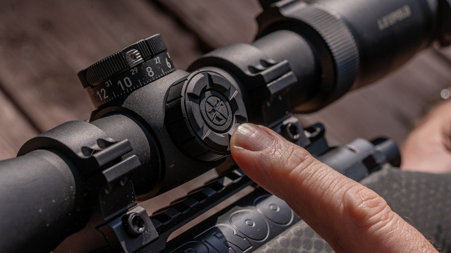A closeup of the illuminated reticle adjustment on a Leupold scope.