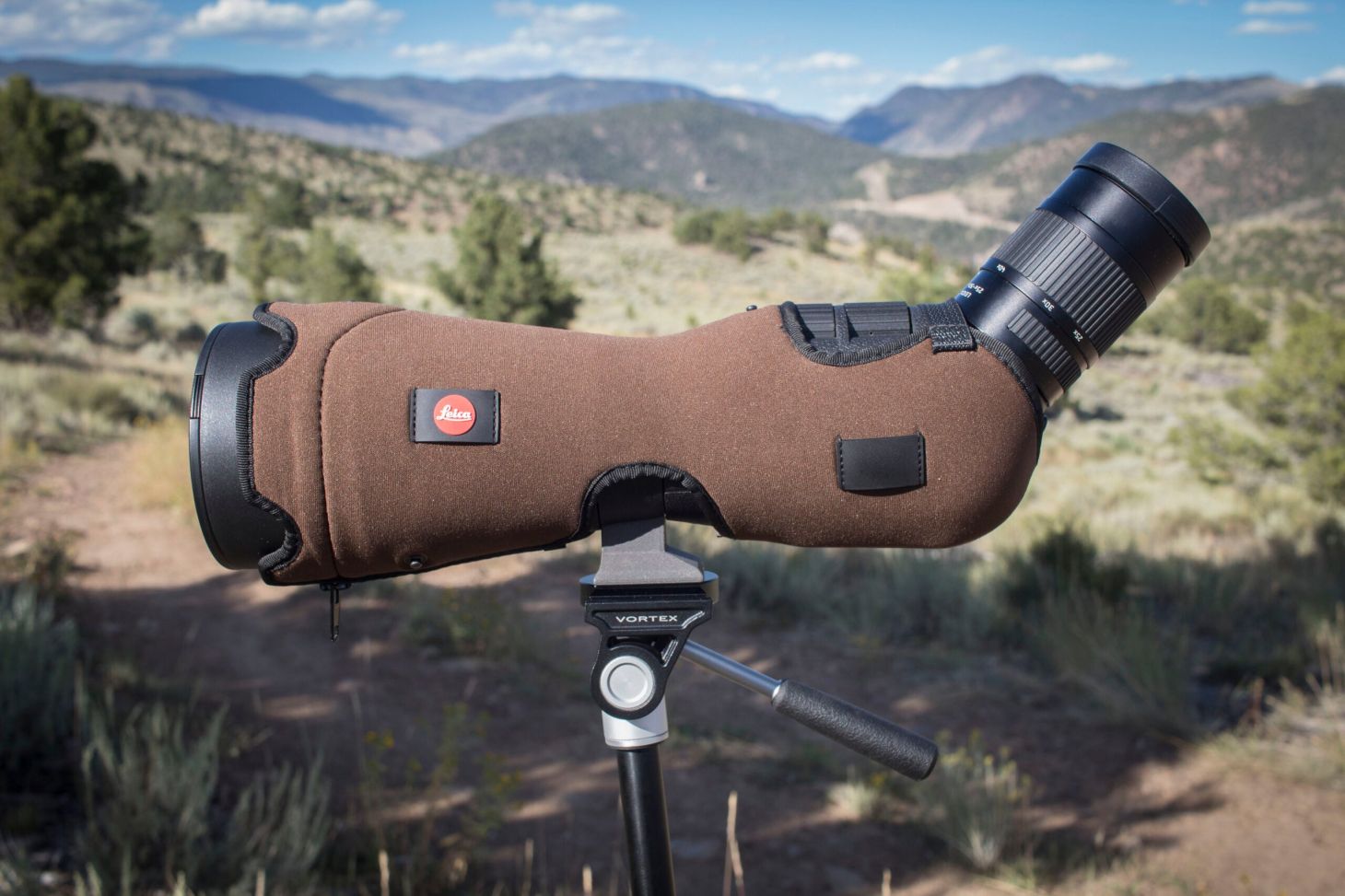 Leica APO Televid spotting scope on tripod with mountains in the background