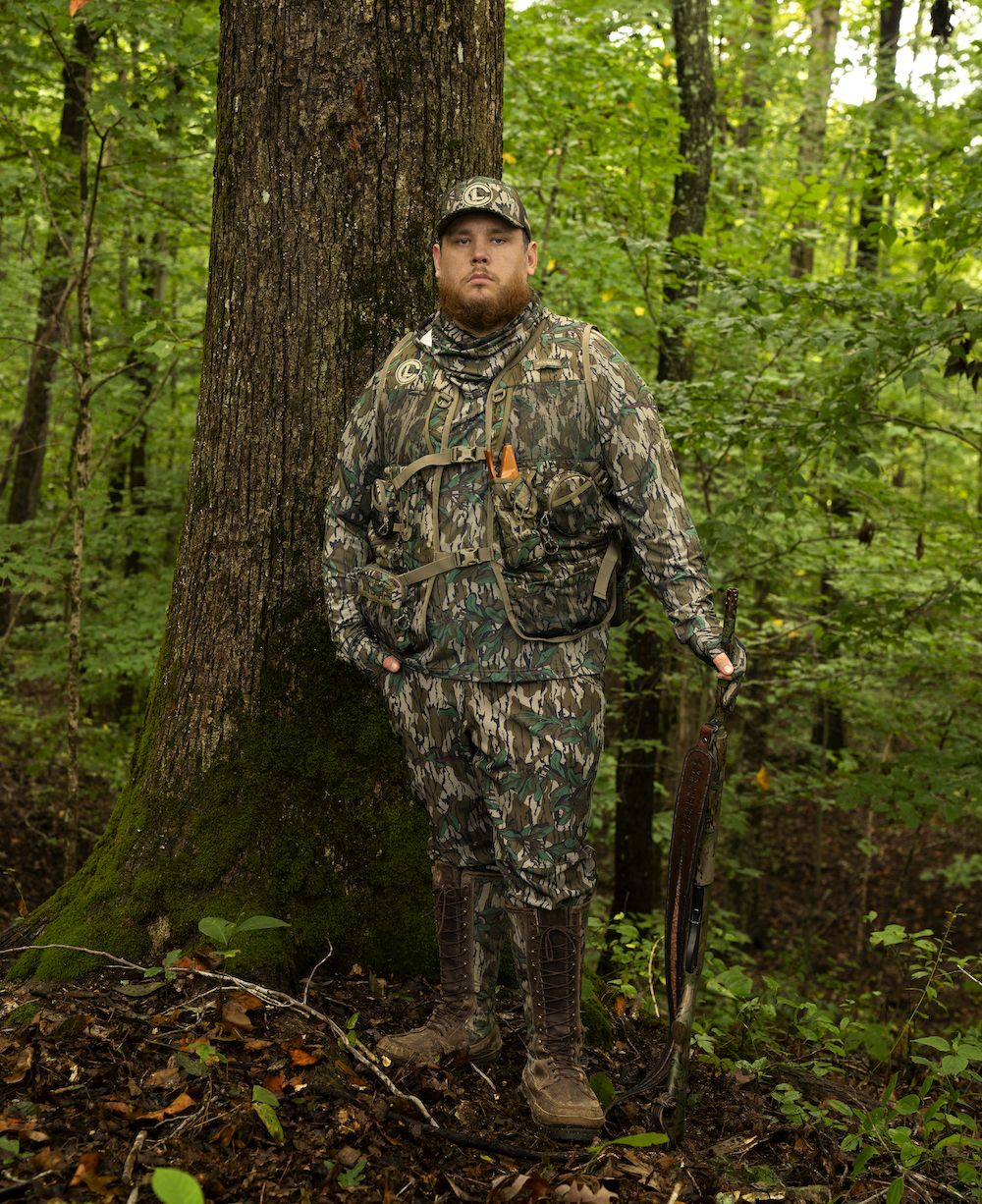 Luke Combs in woods wearing Columbia PHG Mossy Oak Turkey Hunting Line