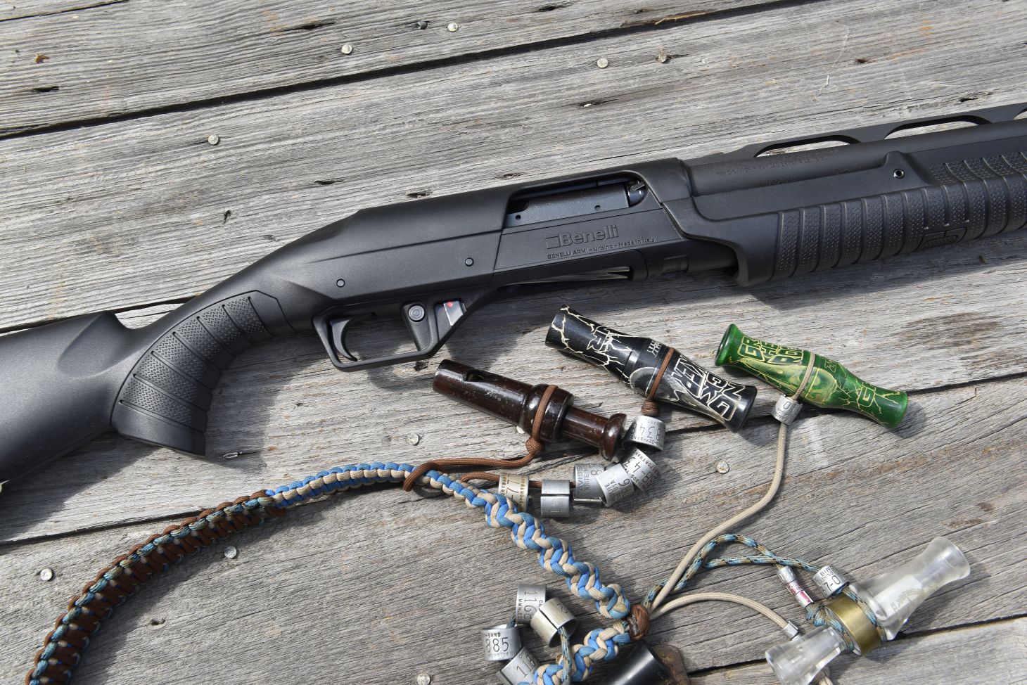 The new Benelli Nova 3 shotgun shown with a lanyard of duck calls. 