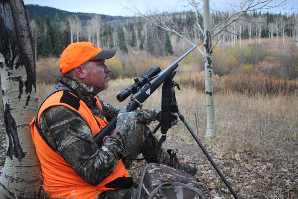 Hunter with a scoped rifle.