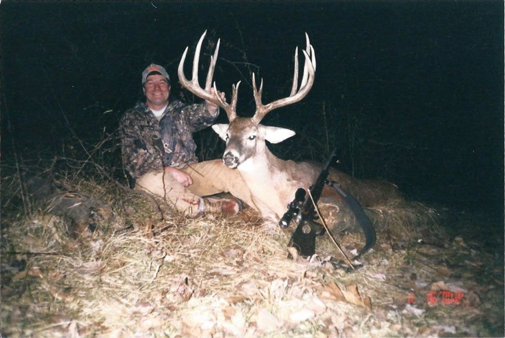 Sam Collora postes with his nearly world record size buck. 