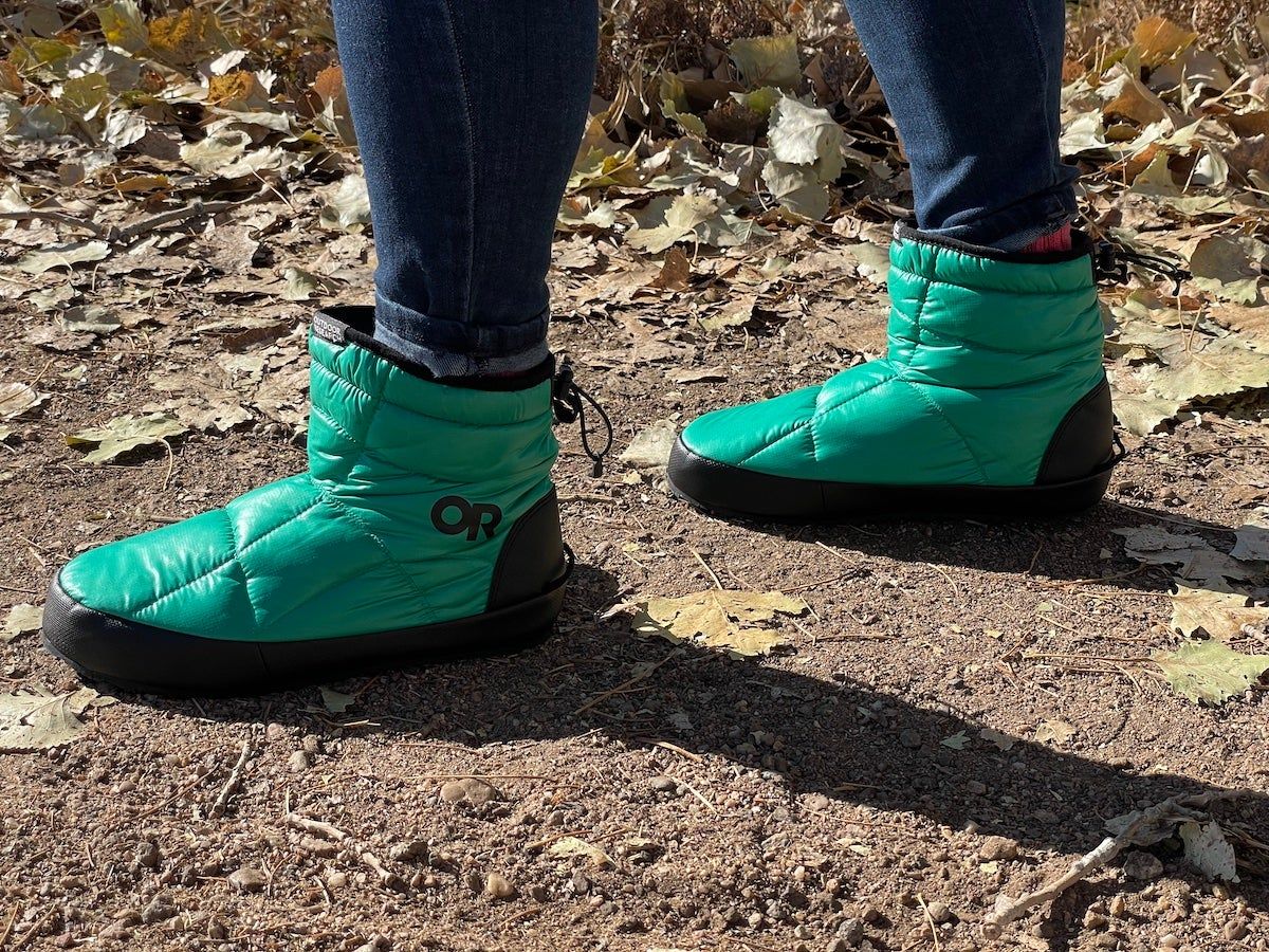 Woman wearing Outdoor Research Tundra Trax booties outside