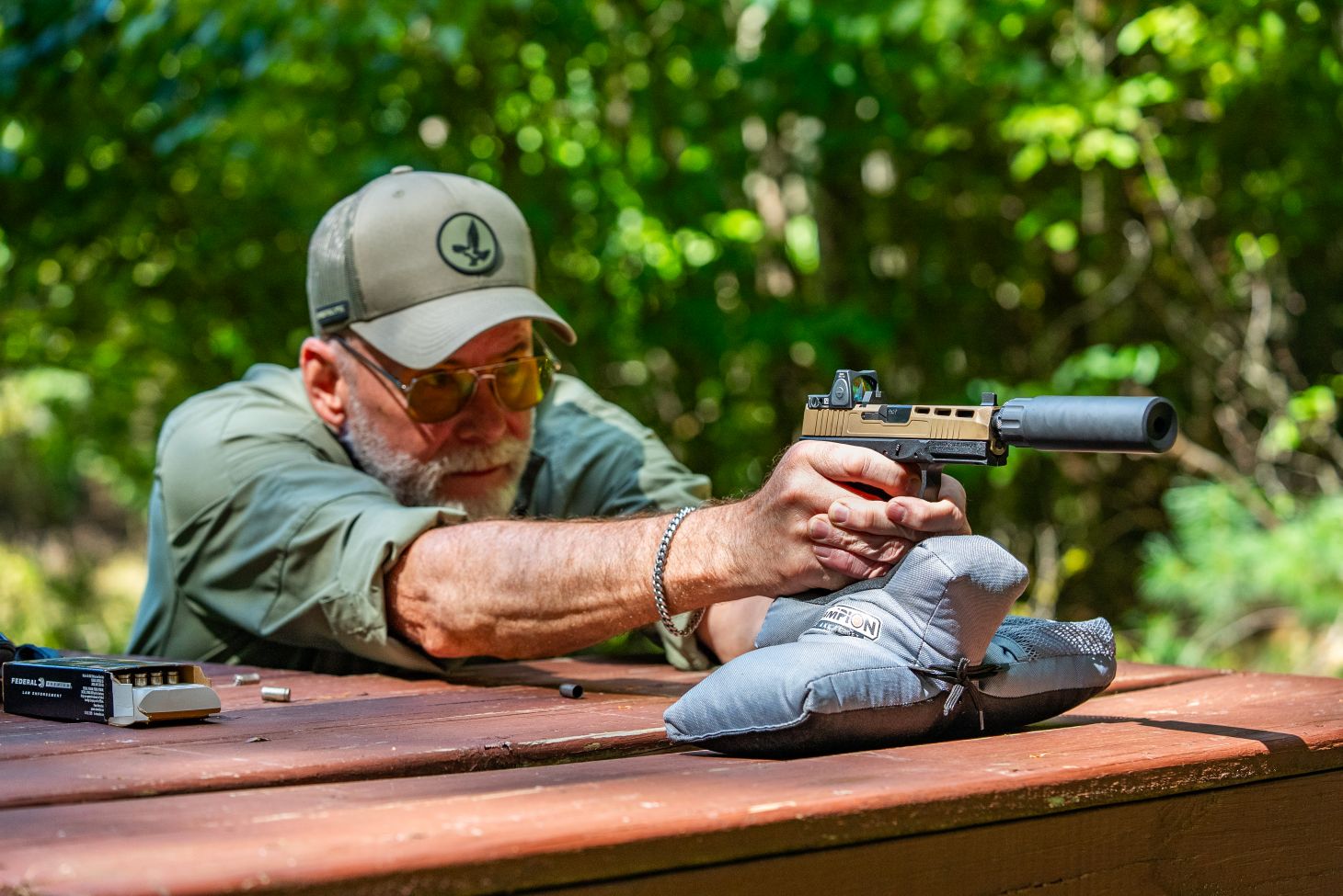 A shooter fires the PSA Dagger from a bench rest. 