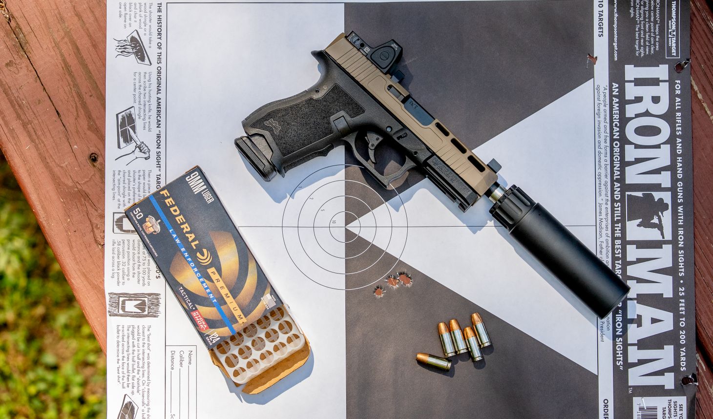 The PSA Dagger equipped with a suppressor next to ammunition.