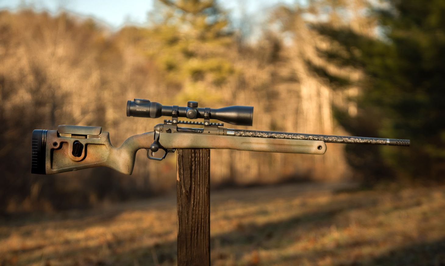 The new Savage 110 PPR bolt-action rifle balanced on a post in a field. 