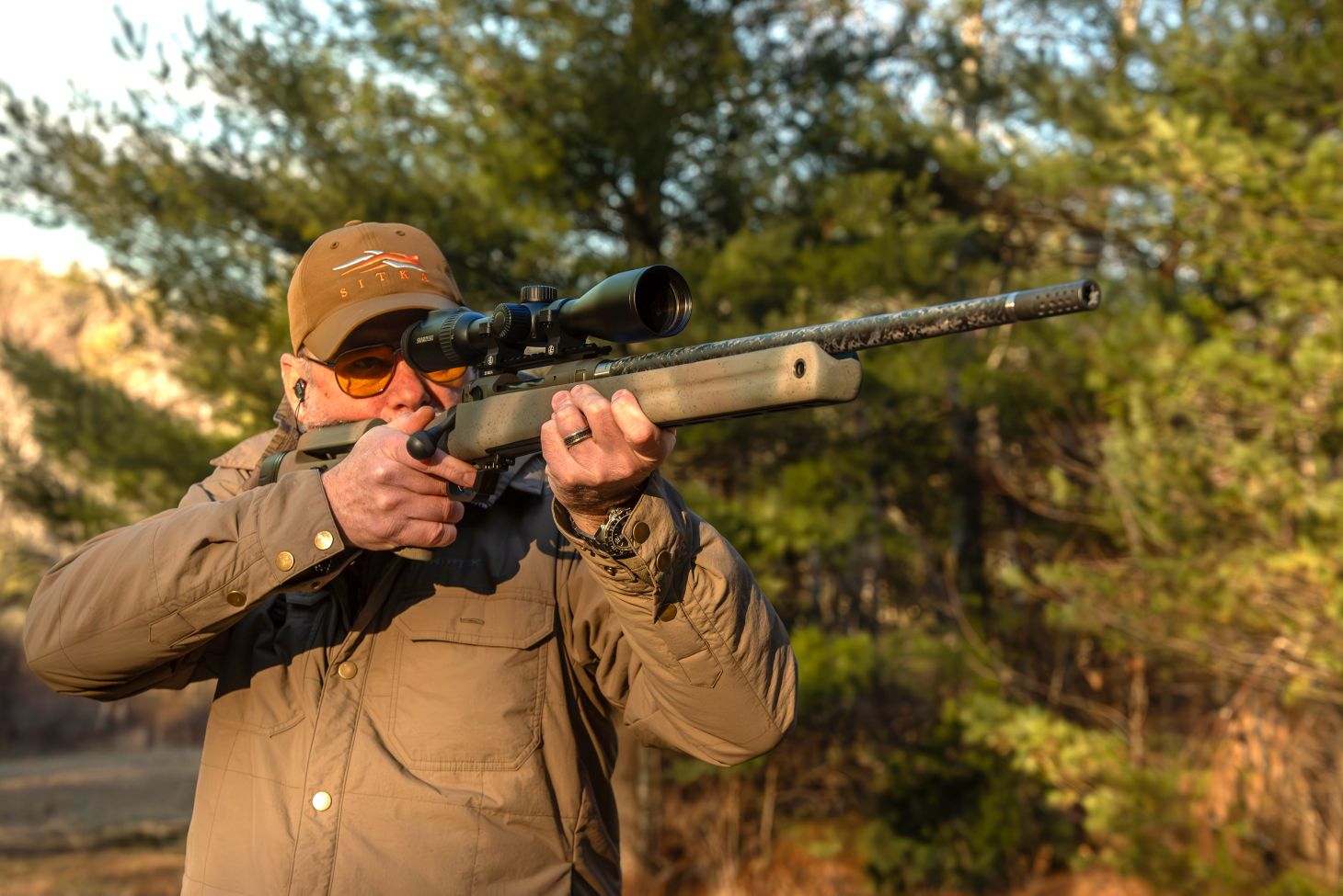 A shooter fires the new Savage 110 PPR rifle from the offhand position. 
