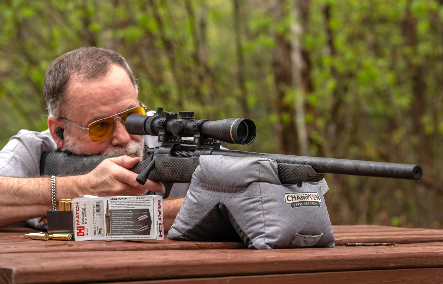 A shooter fires the Proof Research Glacier Ti bolt-action rifle from a bench rest. 