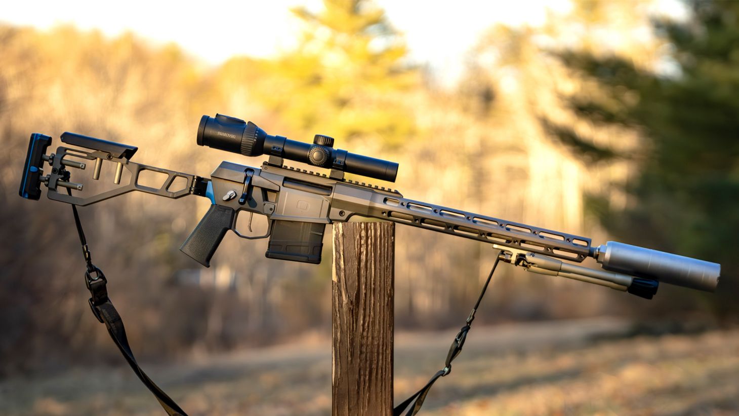 The new Q Fix bolt-action rifle resting on a post with woods in background. 