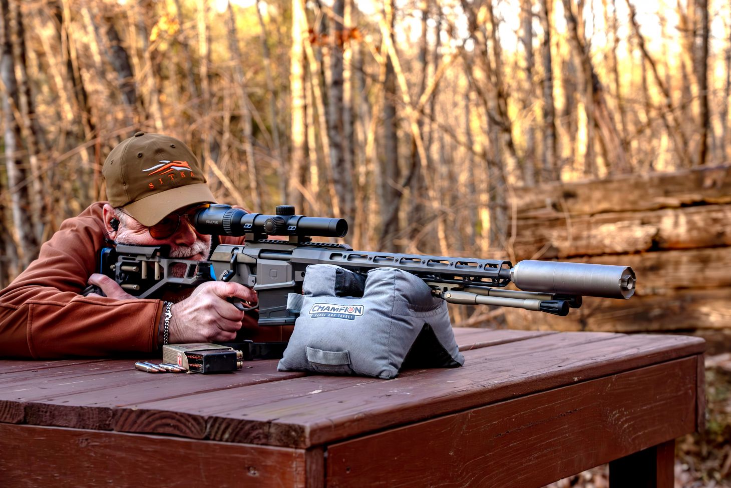 A shooter fires the new Q Fix rifle from a bench rest. 