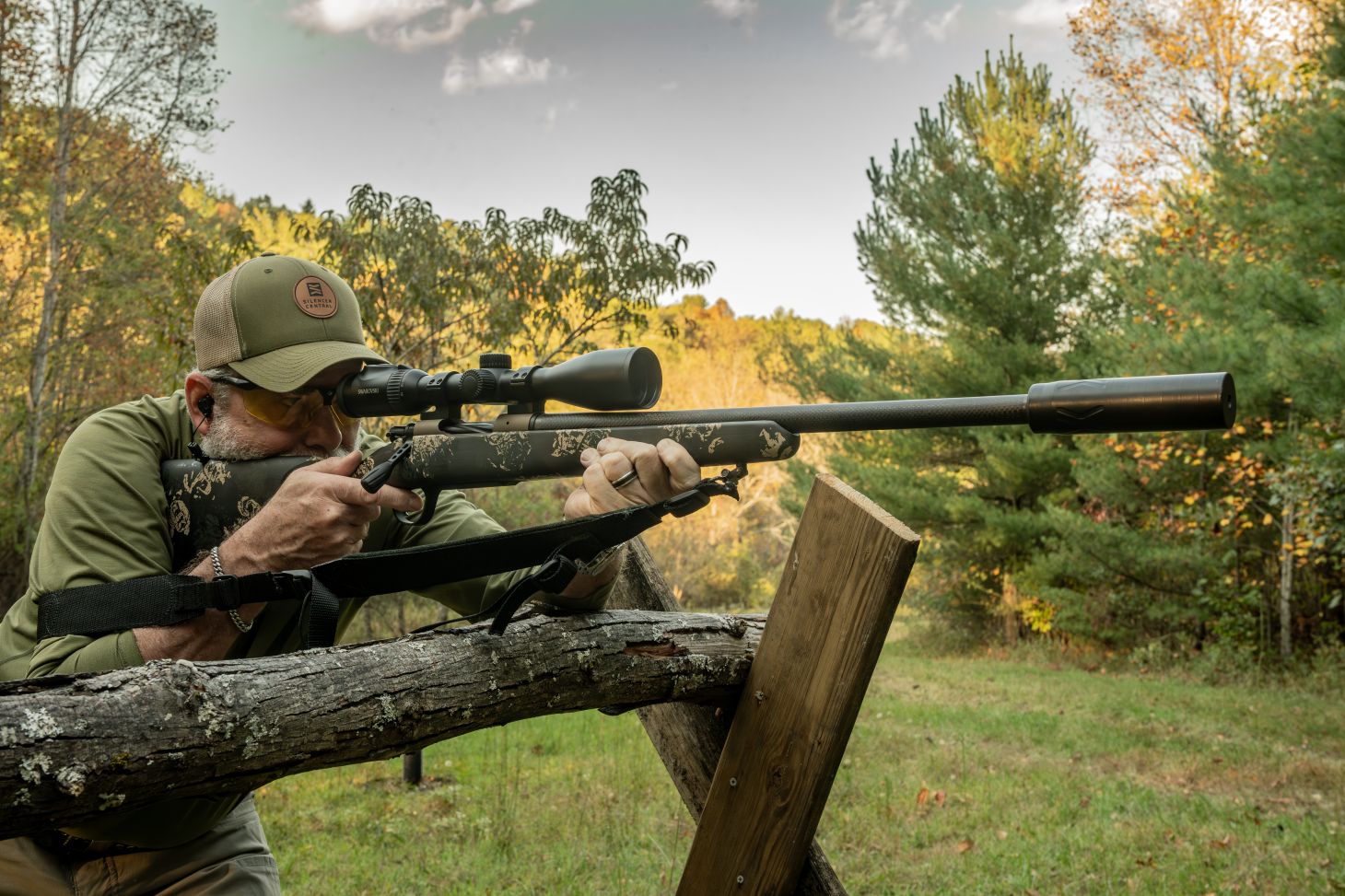 A shooter fires a rifle from a barricade. 