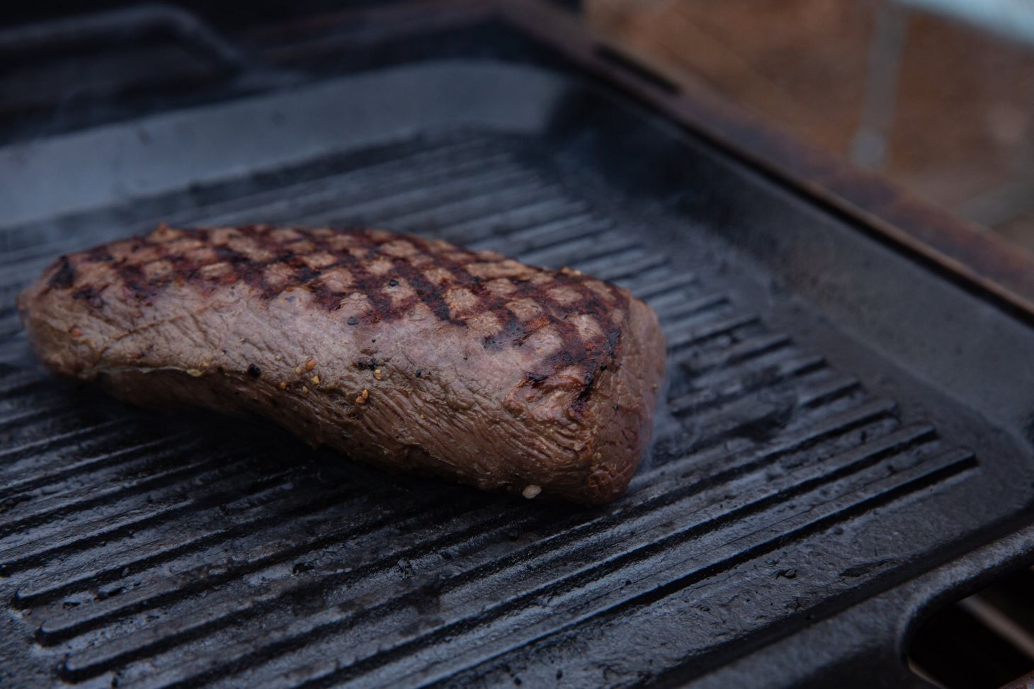 venison roast on a grill.