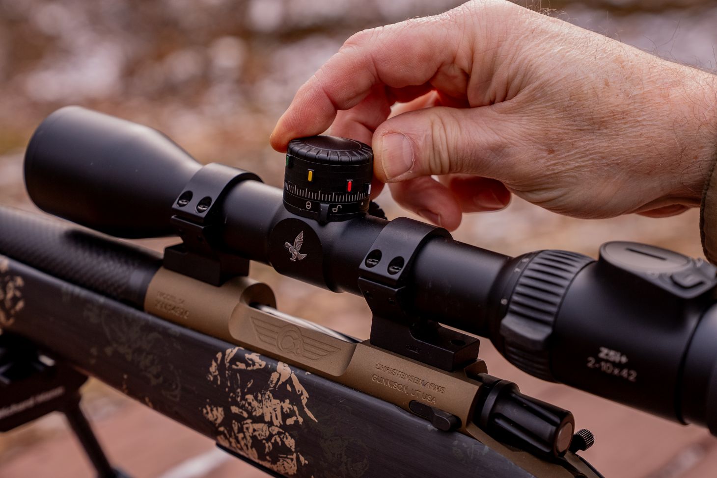A man's hand adjusts the turret on the new Swarovski Z5+ rifle scope. 