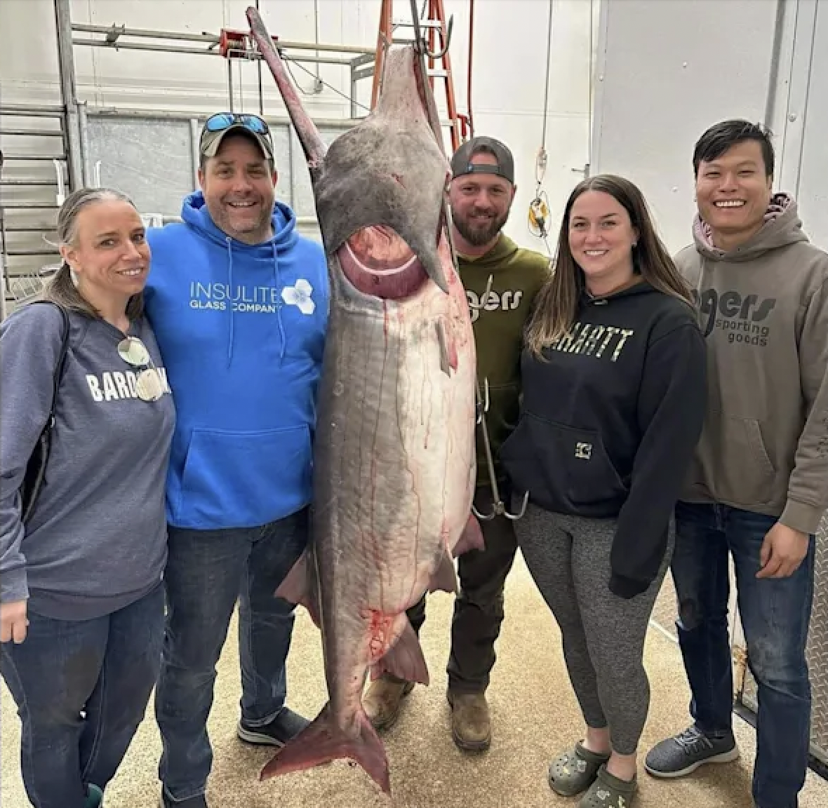 A group of anglers pose with a record-breaking paddlefish in Missouri. 