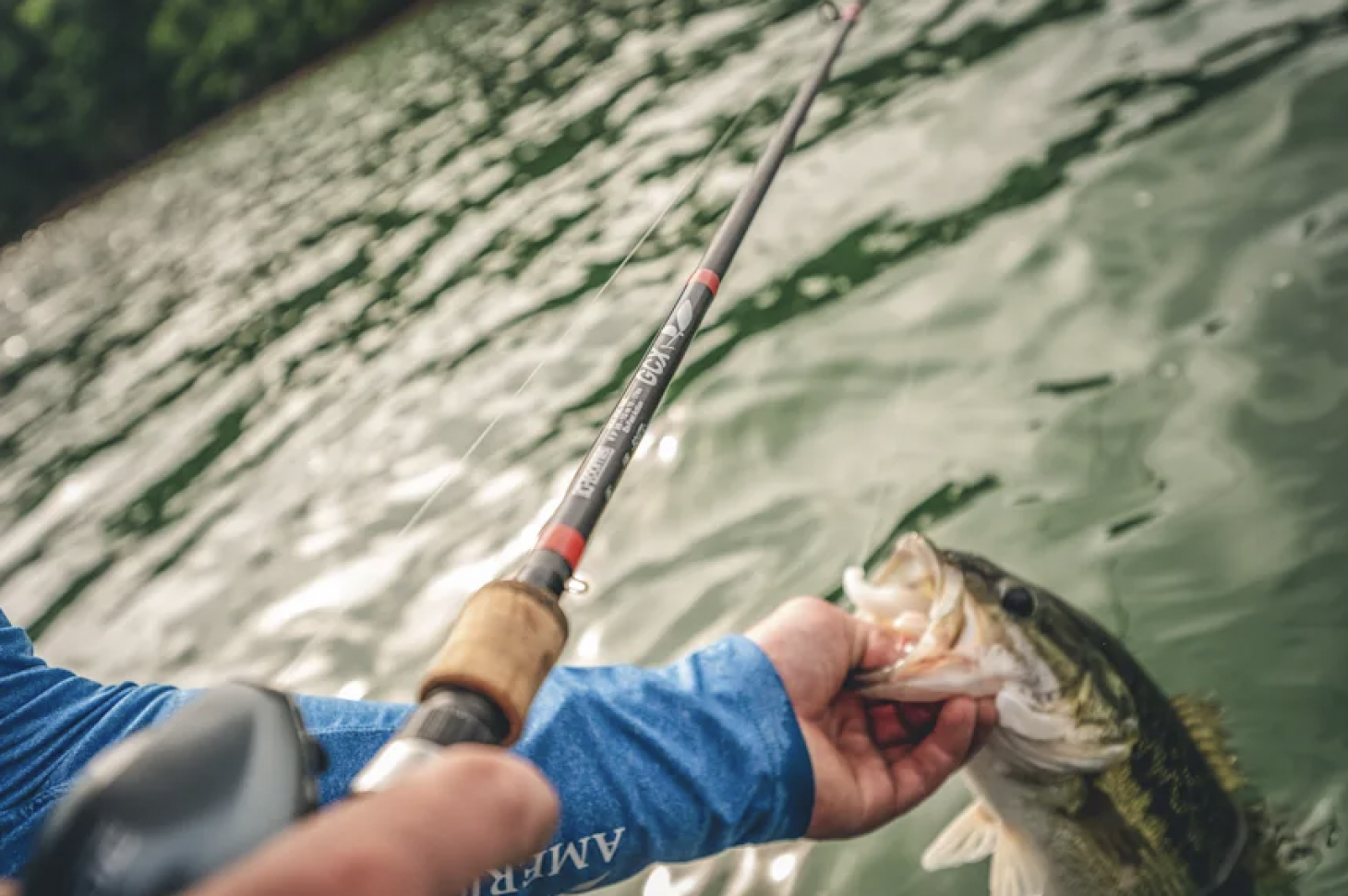 Angler holds up bass with crankbait in mouth