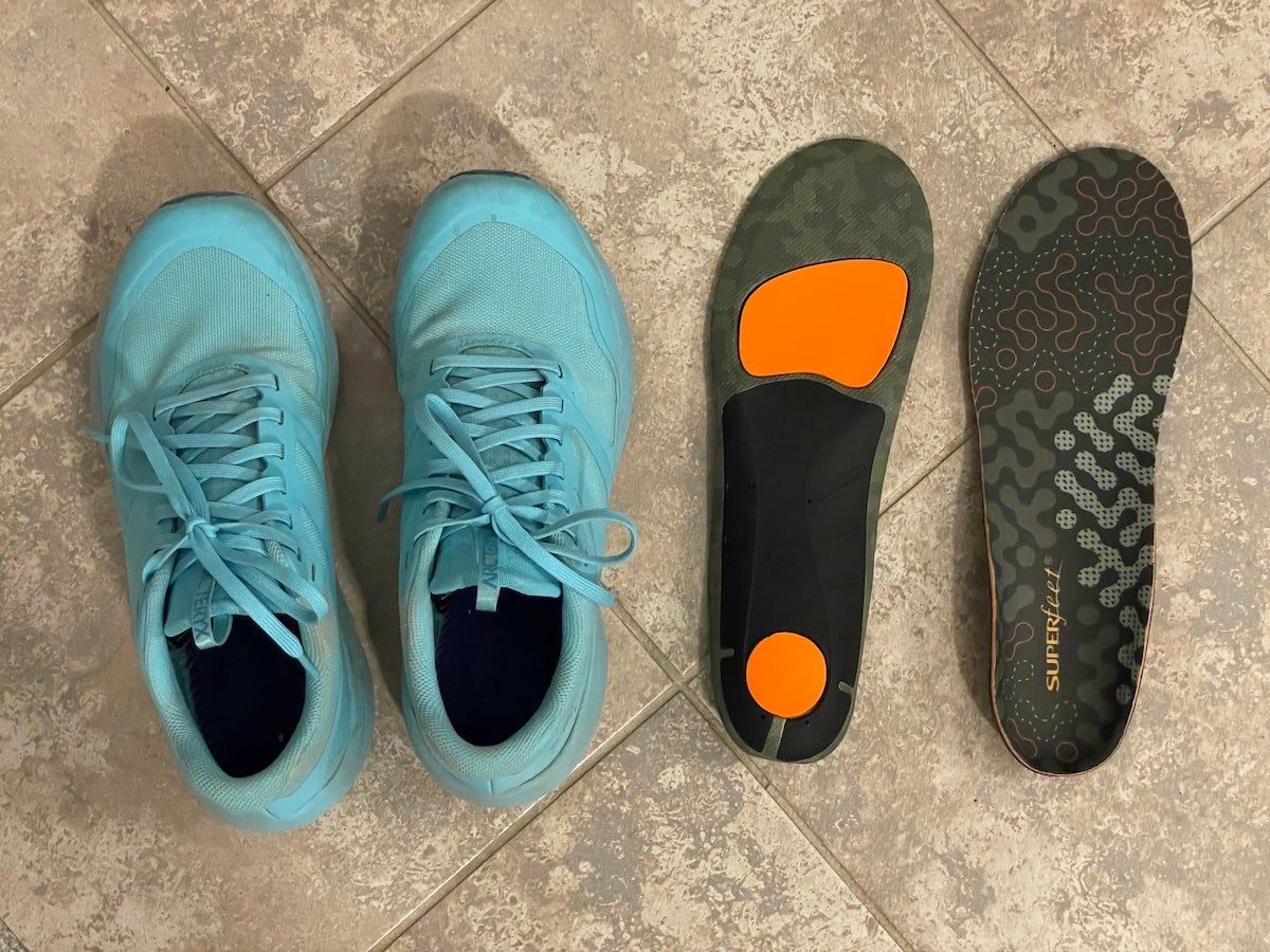 Superfeet Hike Cushion Insoles sitting next to trail running shoes