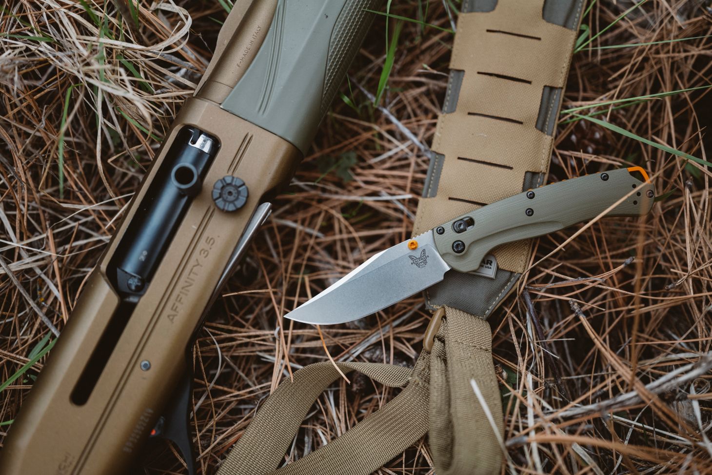 benchmade taggedout on grass with rifle