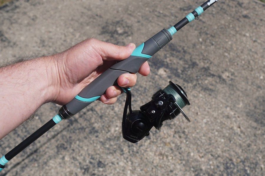 Close-up of angler holding Toadfish Inshore Spinning Combo