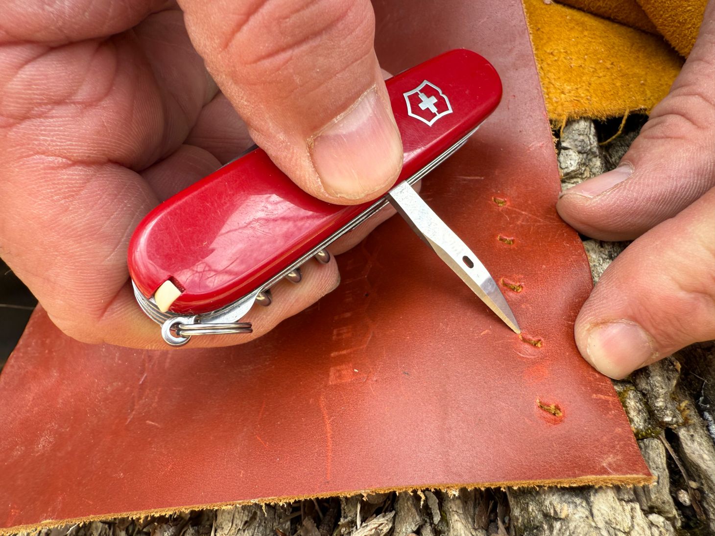 The awl on a Swiss Army Knife Huntsman punches through leather
