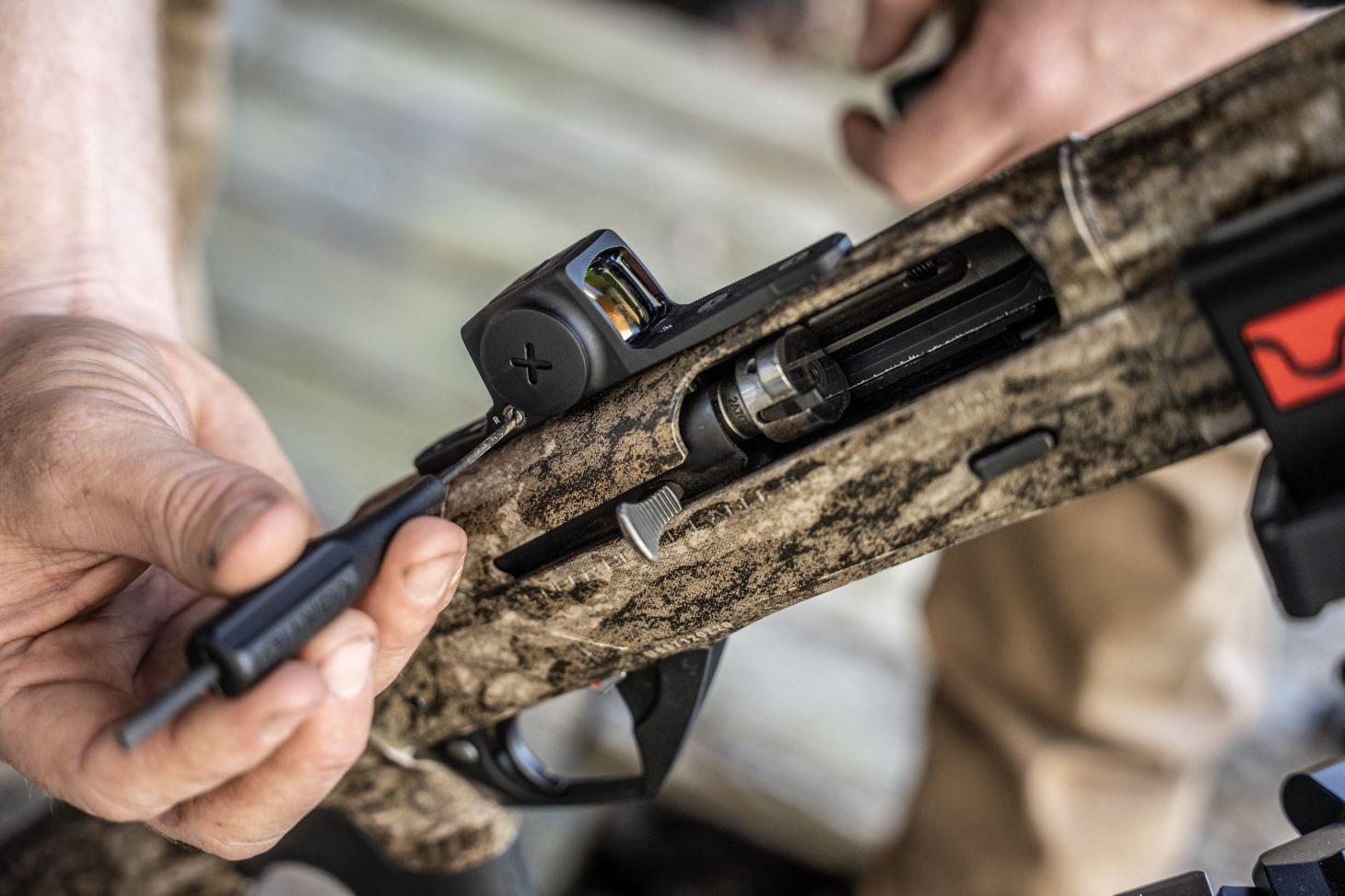 Someone adjusting a red dot