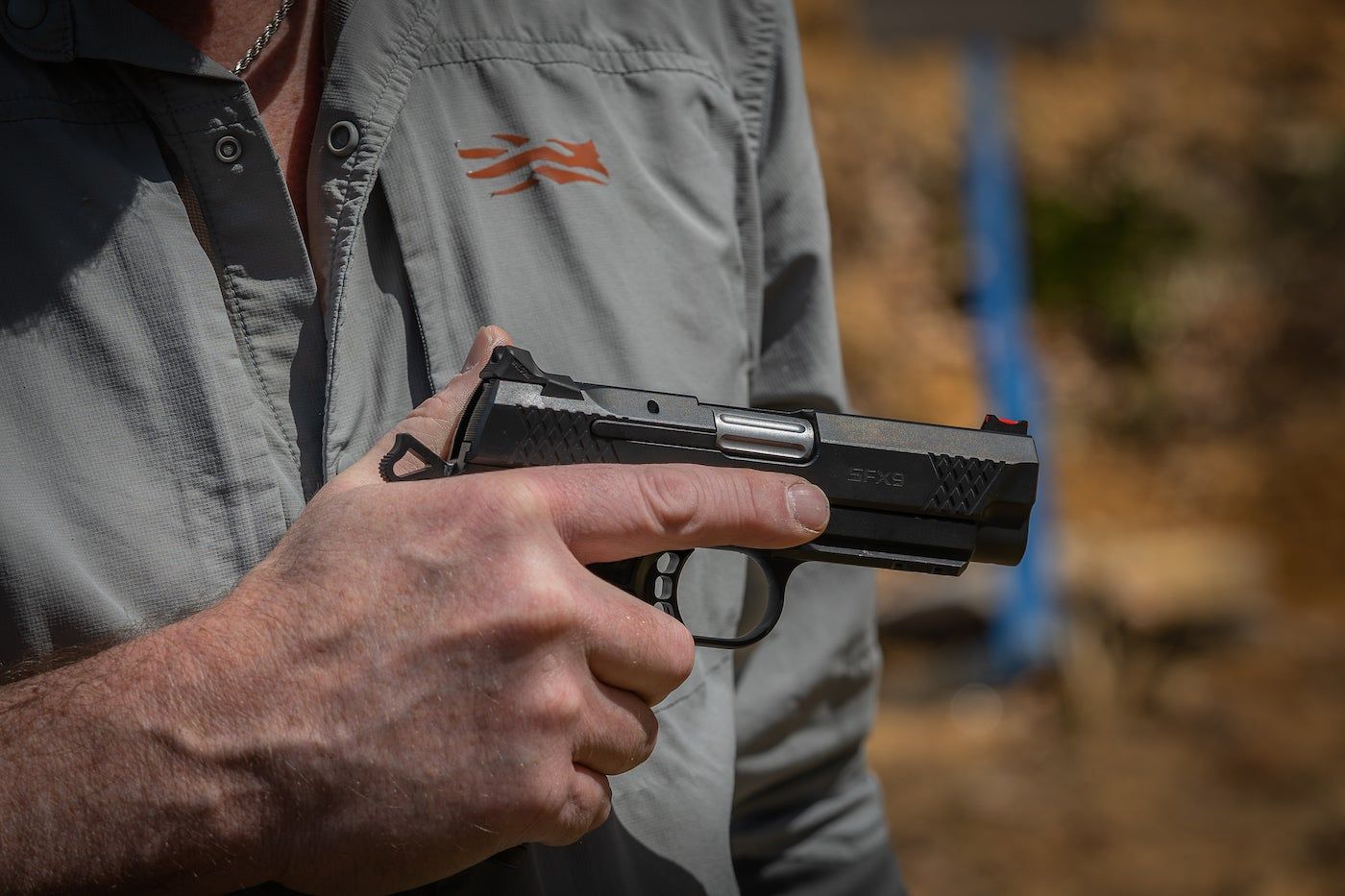 Hand holding a handgun.