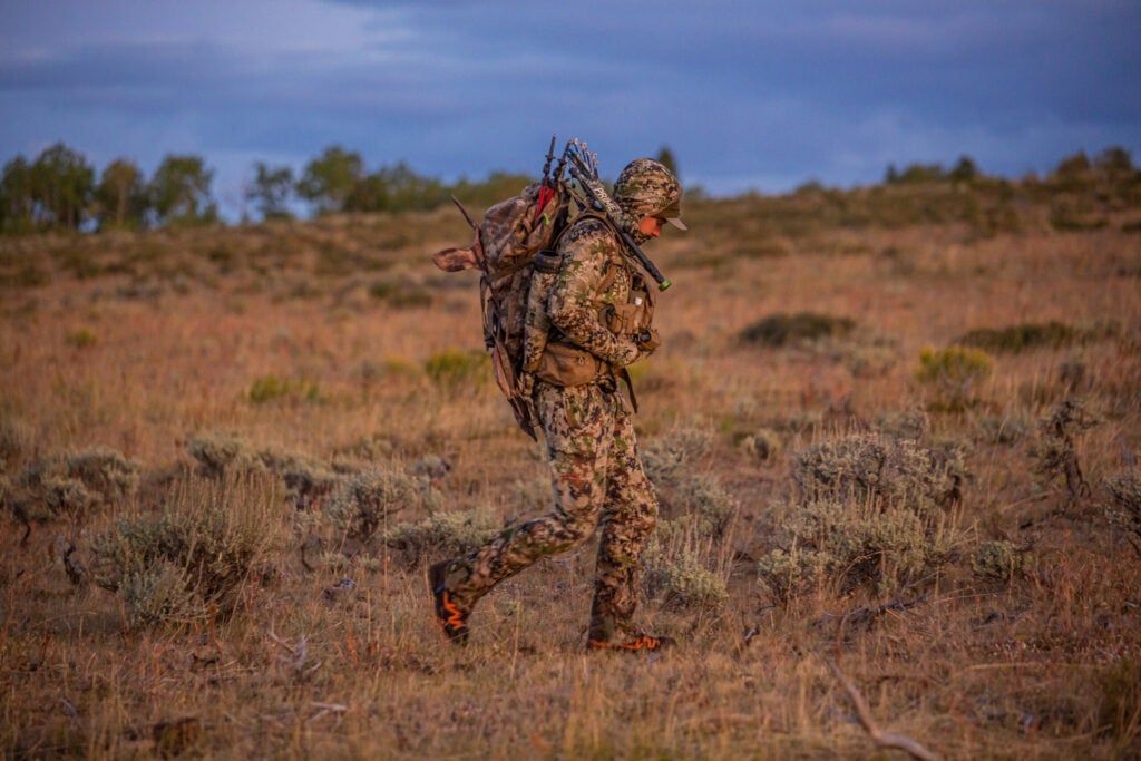 hunter walking through a barren desert field