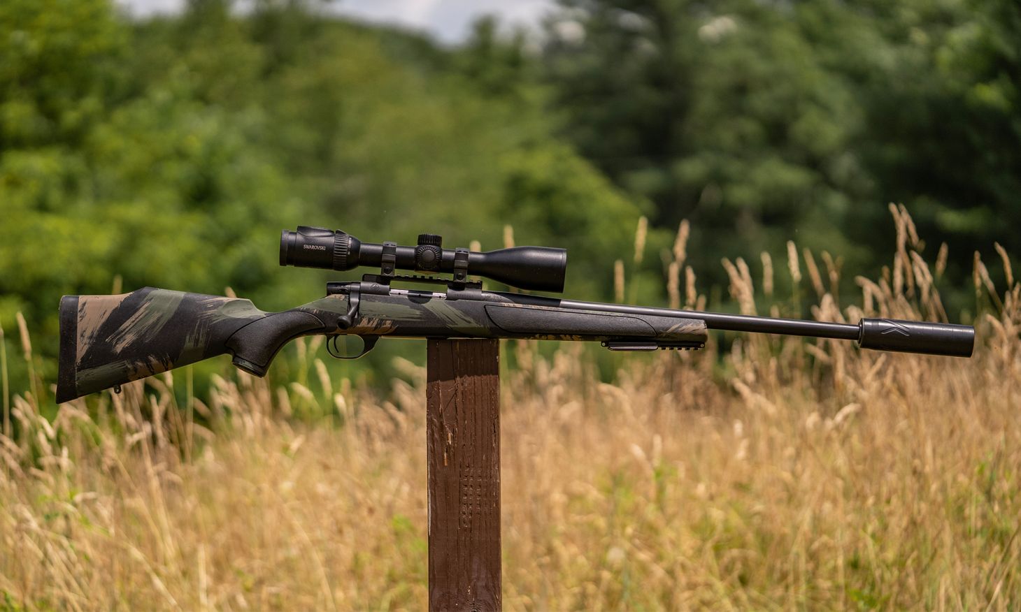 The new Weatherby Vanguard Black Hills bolt-action rifle balanced on a post in a field. 