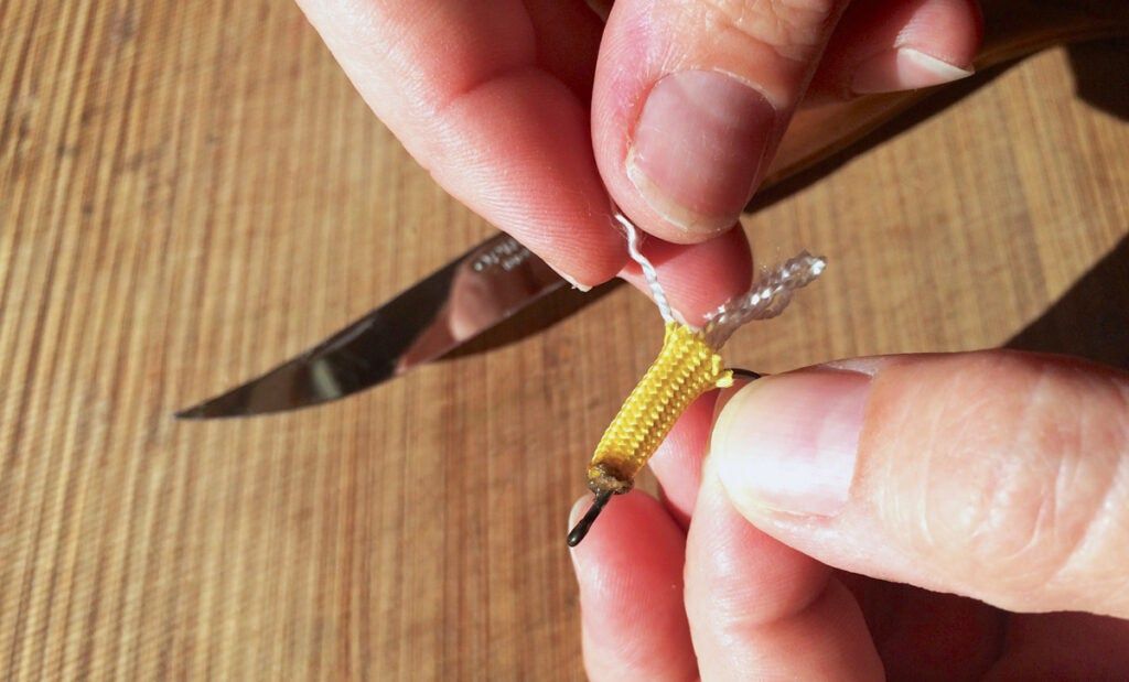 Fray the the yarn on the tail to make the lure more enticing. 