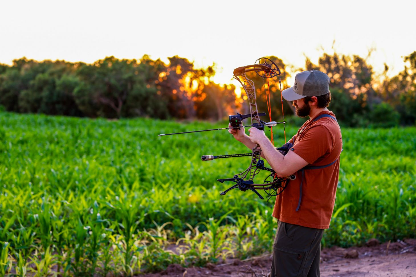 An archer adjusts the sight on his bow for walk back tuning. 