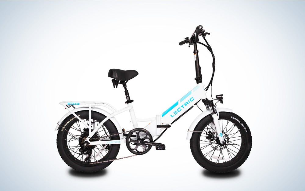 The white Lectric XP step through folding fat tire bike on a black and white gradient background.