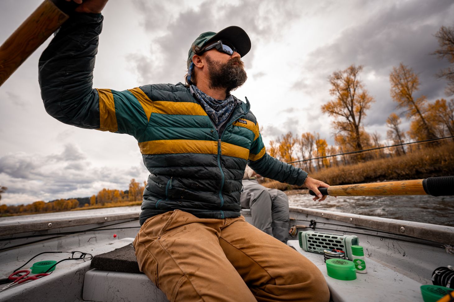 Oliver White rowing a drift boat on the snake river