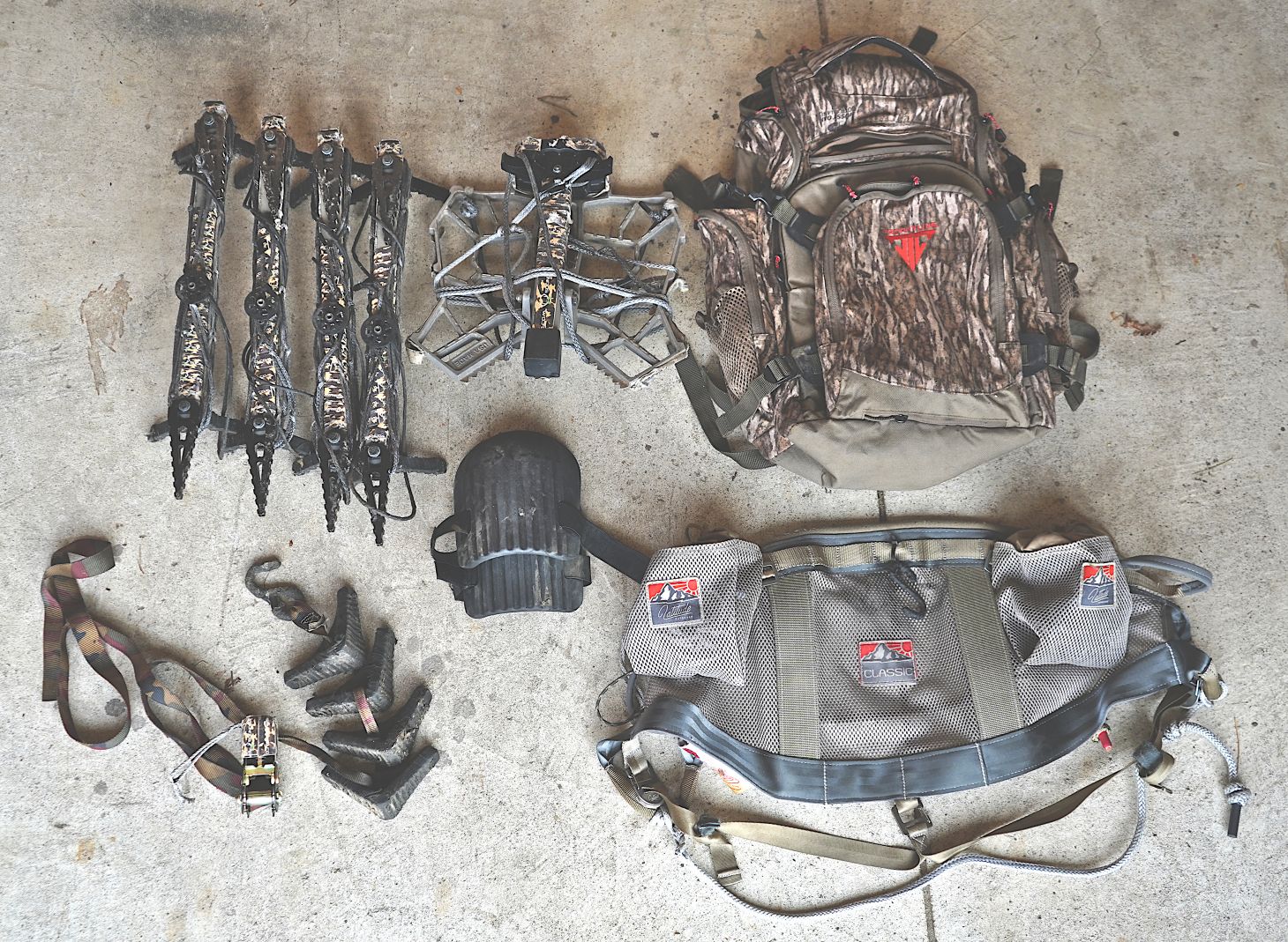 Saddle hunting gear laid out on a floor. 