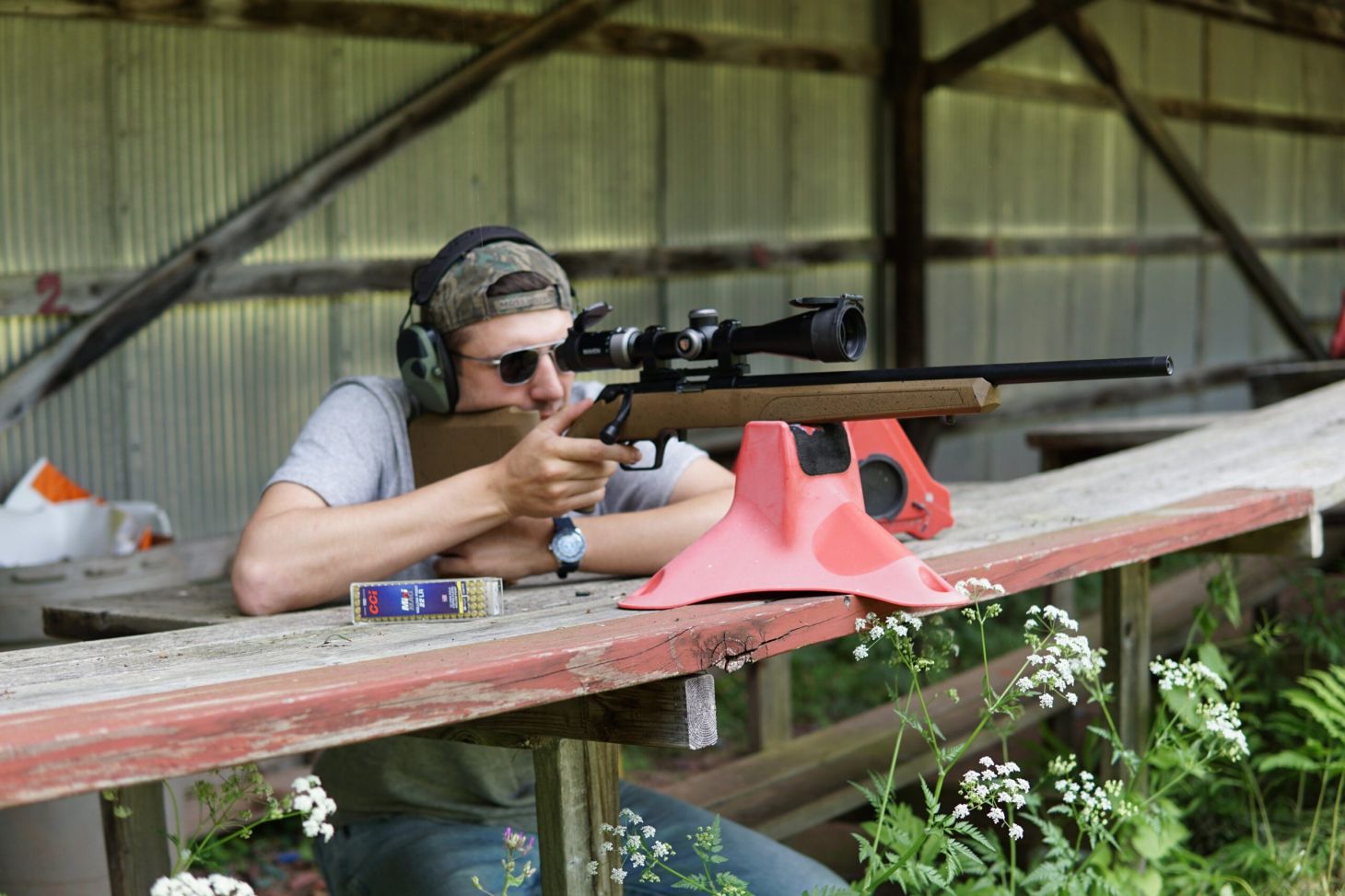 A shooter test firing the Springfield Armory Model 2020 Rimfire rifle from a bench. 