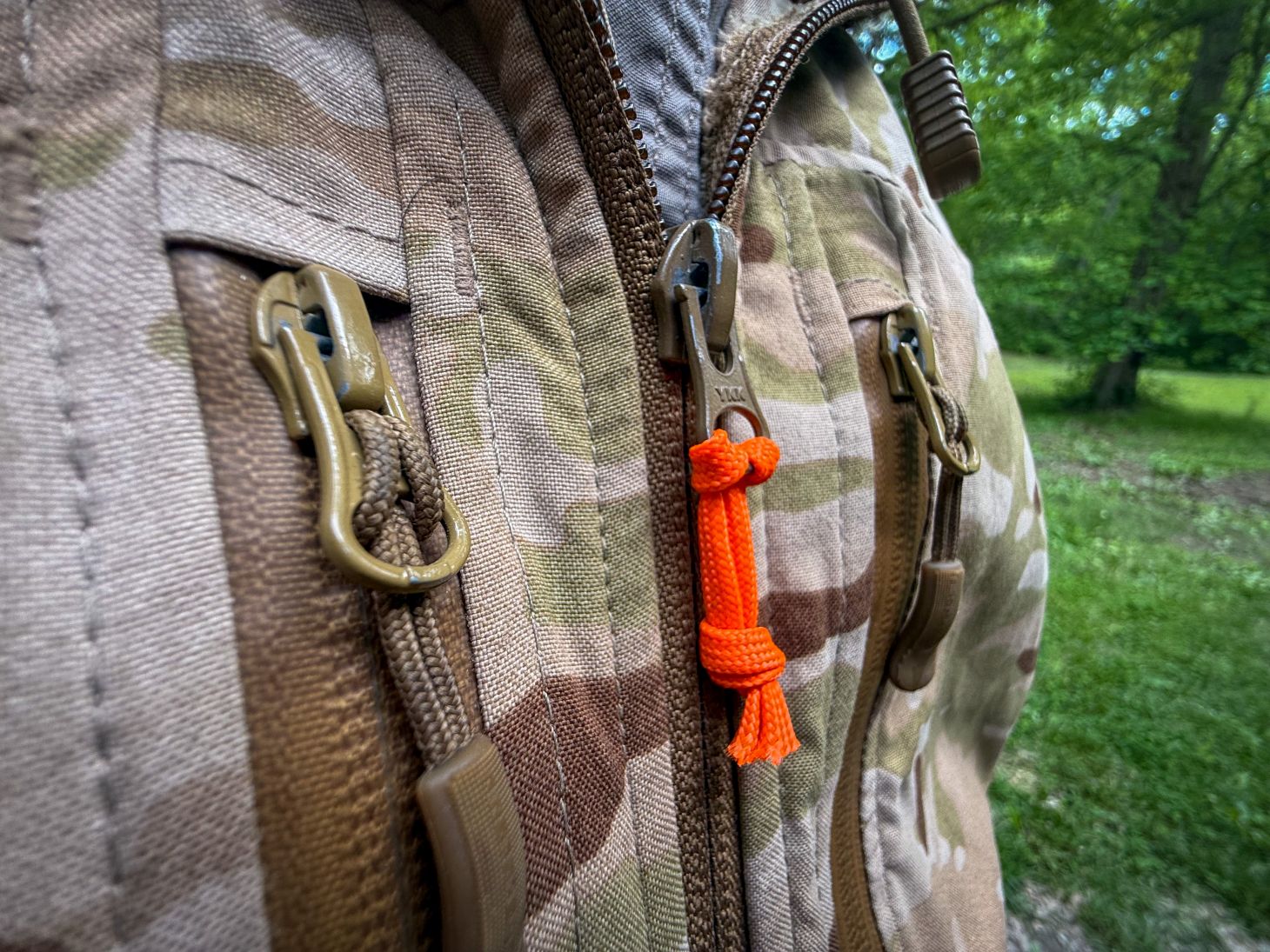 A zipper pull made from orange p-cord.
